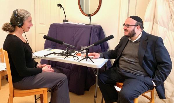Photograph of Aliza Becker interviewing Rabbi Daniel Yolkut